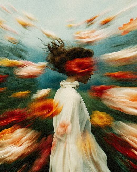 Woman surrounded by swirling colors